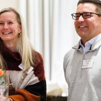 Alumni smile while listening to remarks